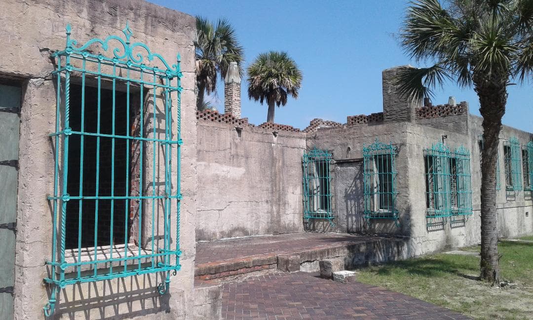 Turquoise window grilles and stone walls at Atalaya Castle in Huntington Beach State Park