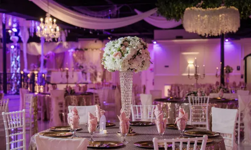 Reception tables and floral centerpieces in a ballroom
