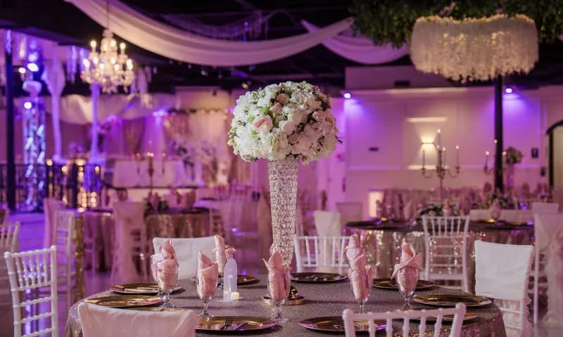 Reception tables and floral centerpieces in a ballroom