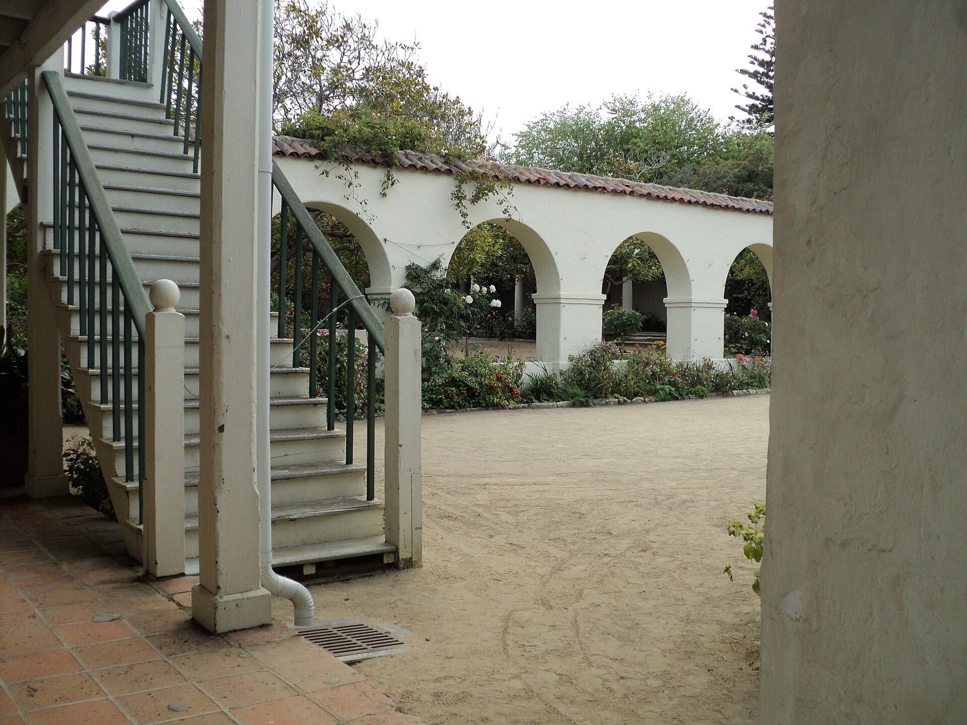 Arched garden walkway and white stairway at Memory Garden in Monterey