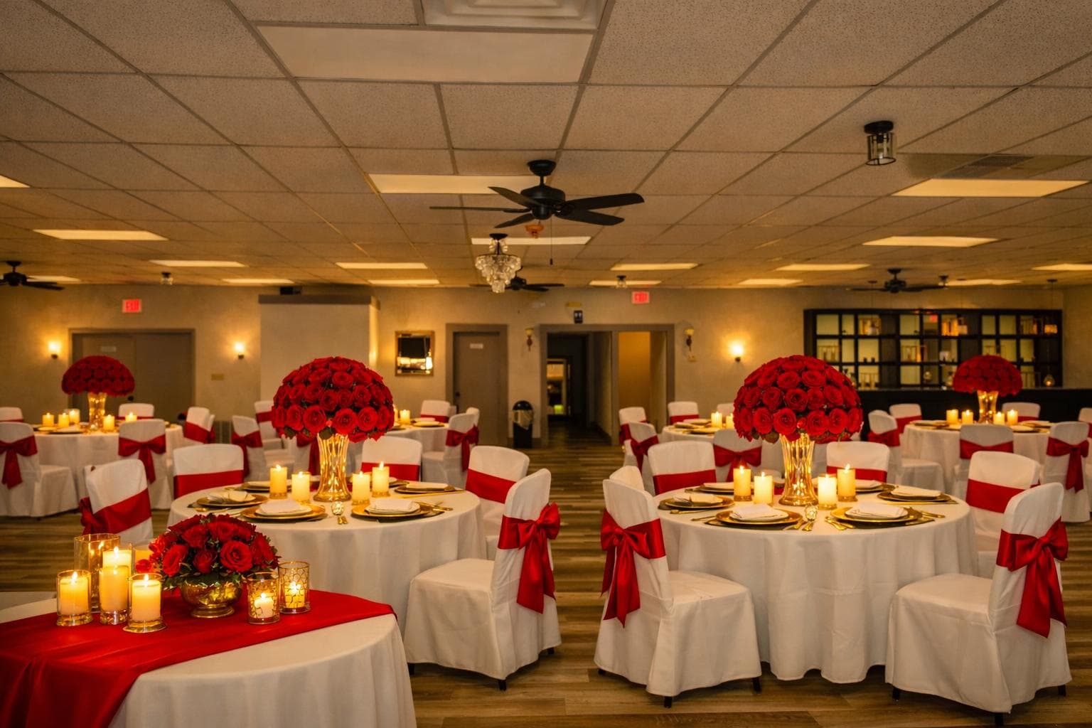 Round reception tables with red flowers inside Tyler Palace