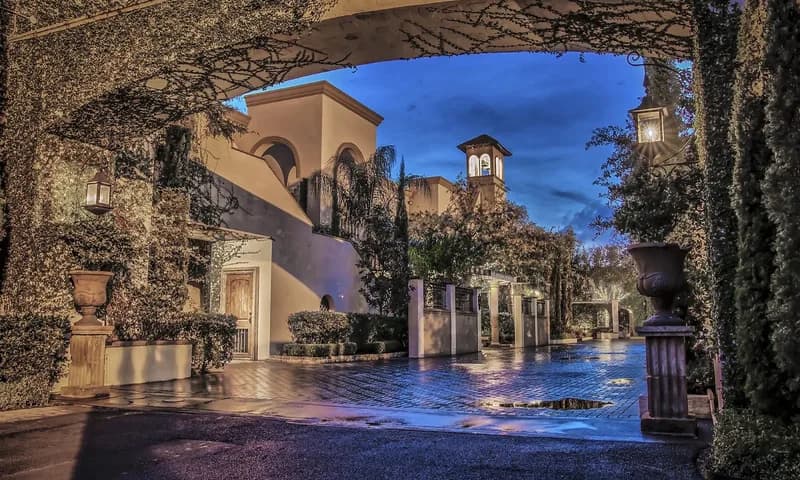 Stone courtyard and arched entrance at dusk