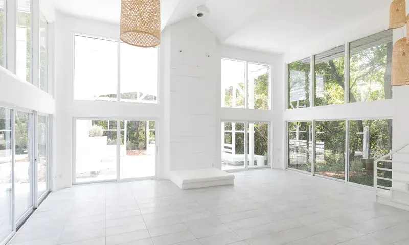 Bright event room with large windows and pendant lights