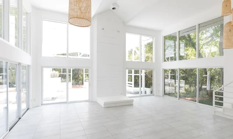Bright event room with large windows and pendant lights