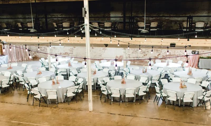 Round reception tables in the warehouse event hall